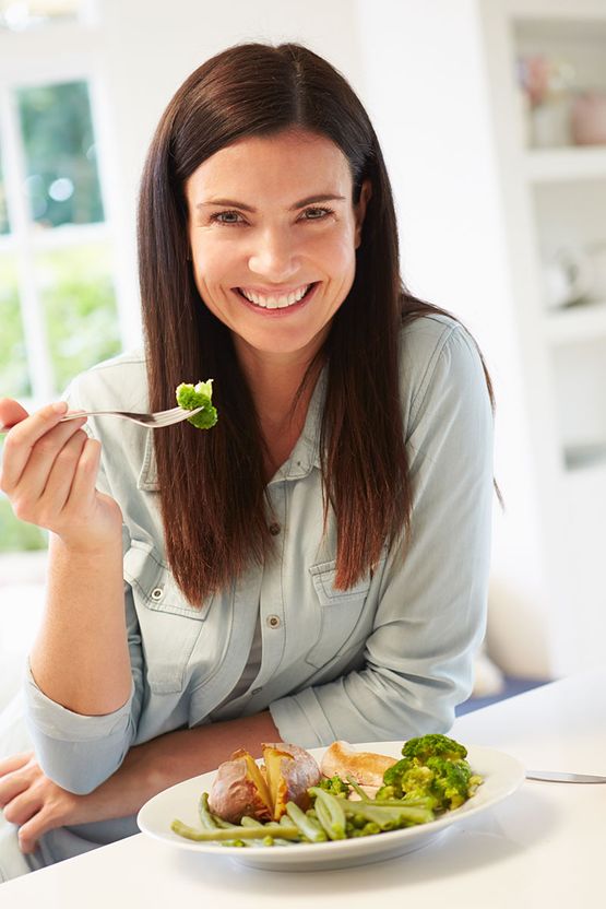 Gesunde Frau beim Gemüse essen